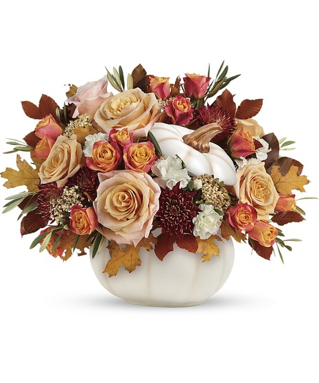 cream flowers in autumnal pumpkin container