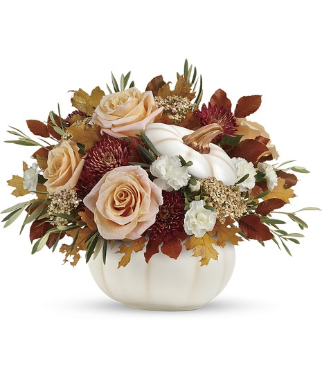 cream flowers in autumnal pumpkin container