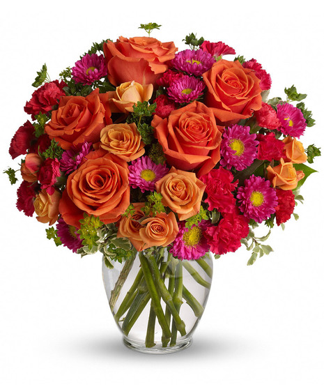 hot pink and orange flowers in ginger vase
