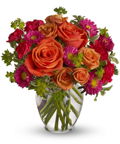 hot pink and orange flowers in ginger vase