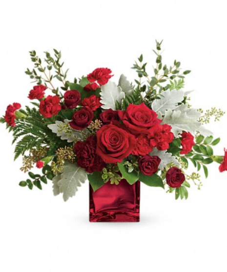 Christmas toned flowers in square vase
