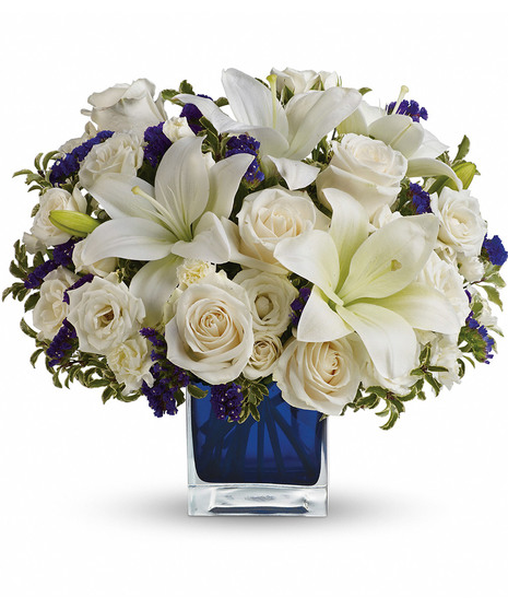 white and blue floral arrangement in blue cube