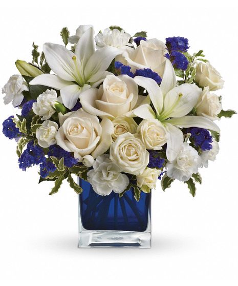 white and blue floral arrangement in blue cube